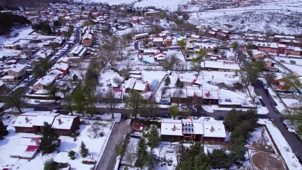 Cinematic tilt-up aerial over the town of Pradera de Navalhorno in Spain on a cold but sunny winter'