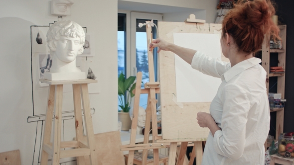Woman Artist Drawing Plaster Bust in the Workshop