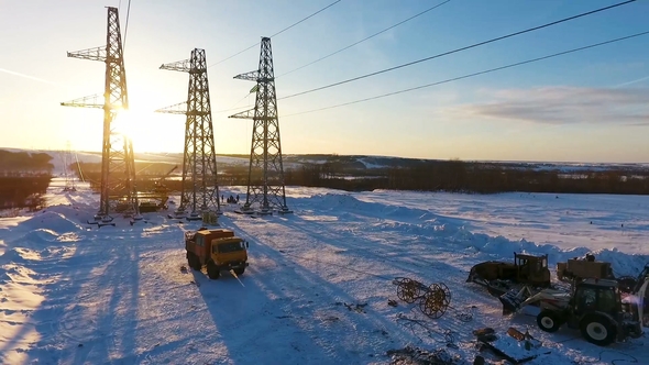 Trucks at Station Construction Against Winter Sunset