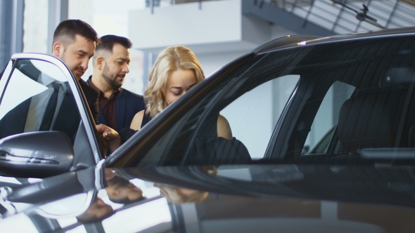 Family Taking Seats in New Car in Salon