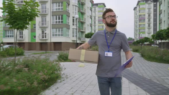 Young Bearded Man Searching Client Address To Deliver Box