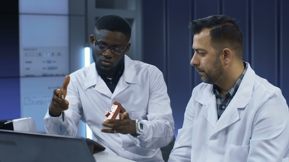 Scientists Investigating 3-D Printed Model alt