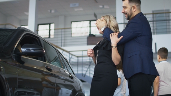 Happy Family Getting New Car in Salon