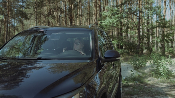 Pretty Blonde Woman Getting Out of Luxury Car