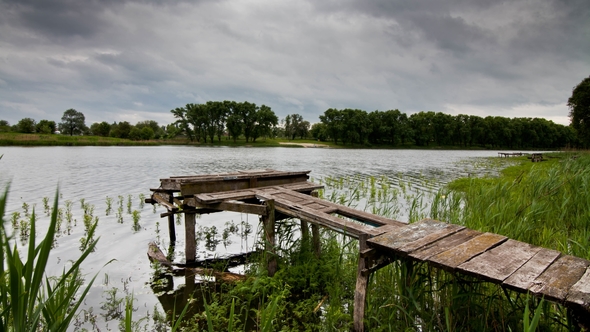 Old Fishing Bridge on the Lake on a Cloudy Day