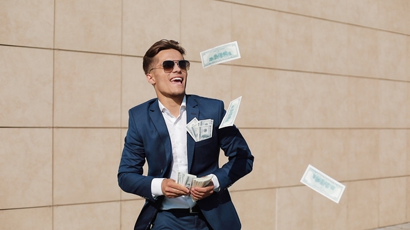 Young Happy Businessman Dancing and Throwing Money Successful Business or Winning the Lottery