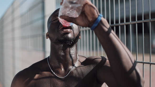 Black Tired African American Male Athlete After Hard Training Drinking Clean Cool Water, Pours Out