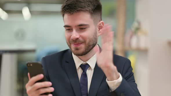 Young Businessman Doing Video Chat on Smartphone 