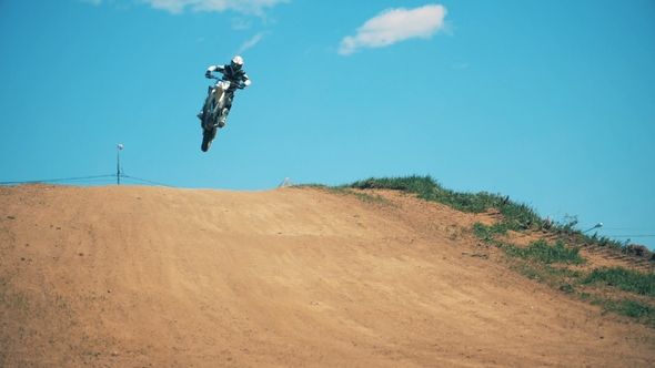 Driver of a Motorcycle Is Performing a Jumping Trick