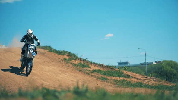 Sportbike with Its Pilot Is Riding Down the Hill