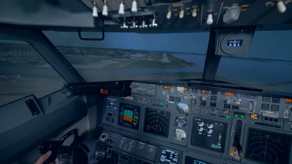 Two Men Are Landing an Aircraft in a Flight Simulation