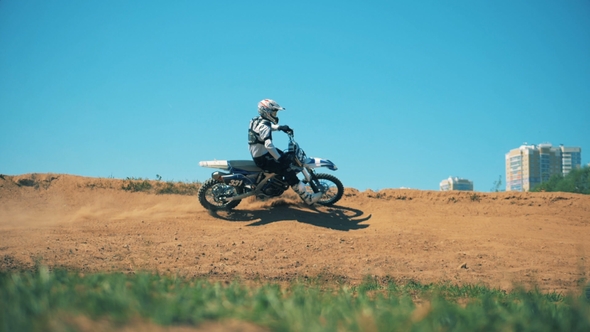 Professional Motorcycler Is Driving Across Sandy Terrain