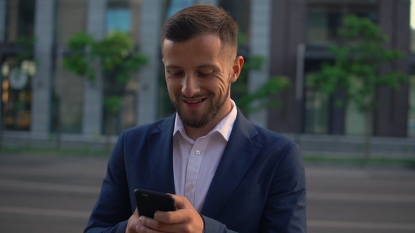 Caucasian Man Use Mobile in City