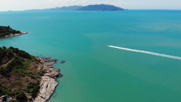 Beautiful Ocean with Track on Water. Breathtaking Aerial View of Rocks, Turquoise Water and Jet Ski