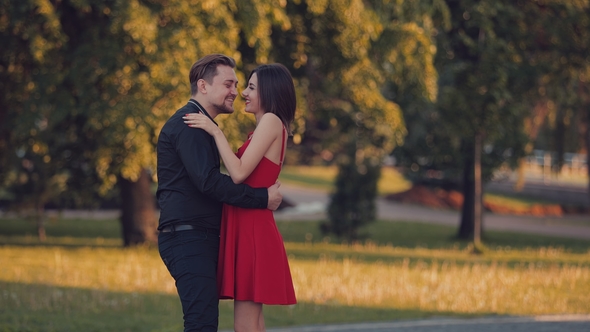 Young and in Love Couple in the Park at Sunset