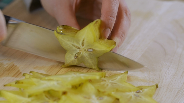 Fresh Carambola Cut on Chopping Board