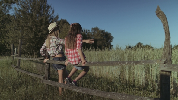 Mother and Daughter Resting in Nature at Sunset