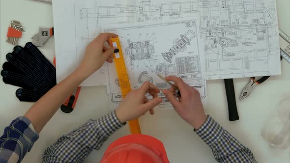 Architects Checking Blueprints with Divider Compass and Ruler