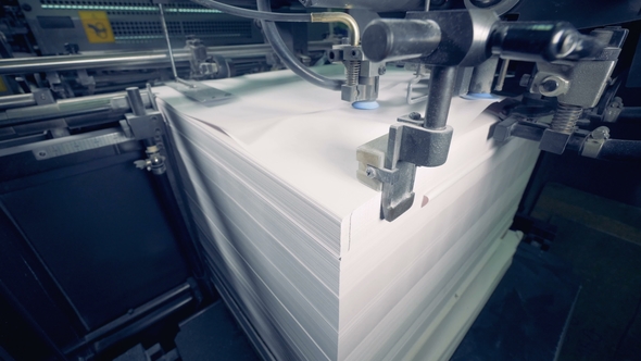 A Machine Divides Lot of Paper Sheets, . Paper Production Process.