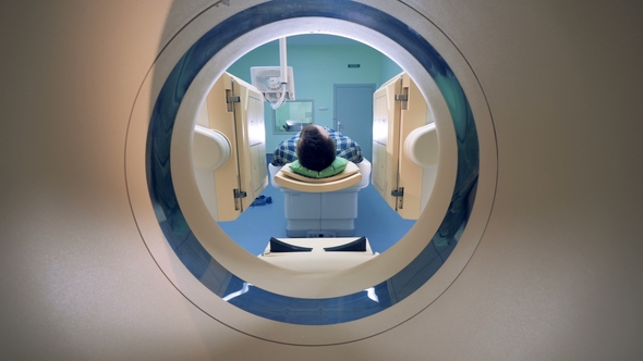Male Patient Is Moving Into a CAT Scanner. alt
