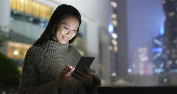 Woman Working on Smart Phone at Night