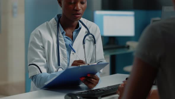 Close Up of Medic Writing Information on Checkup Papers