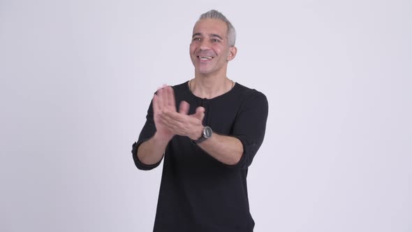 Happy Persian Man Clapping Hands Against White Background