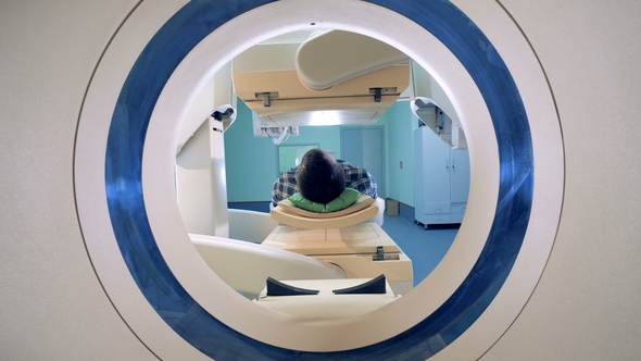 Patient Lying in a Tomograph. Medical Equipment: Computed Tomography Machine in Diagnostic Clinic alt