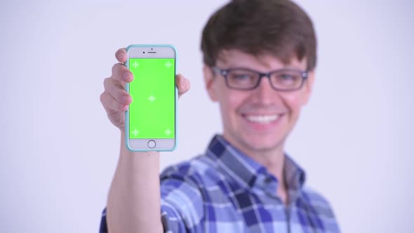 Face of Happy Young Handsome Hipster Man Showing Phone