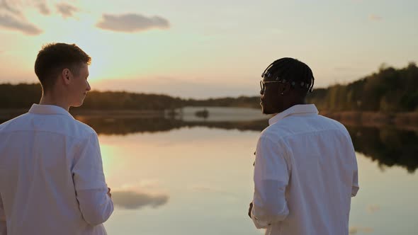 Handsome Young Men Spend Sunset at the Beach Vaping and Drinking