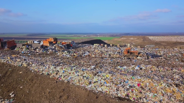 City Dump. The Bulldozer Moves Along the Landfill, Leveling the Garbage