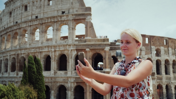 A Woman Is Photographed Against the Background of the Famous Colosseum in Rome