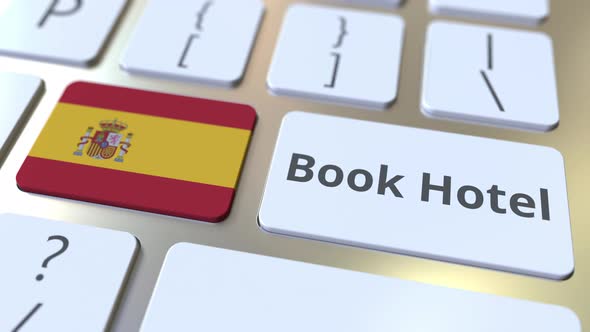 BOOK HOTEL Text and Flag of Spain on Computer Keyboard