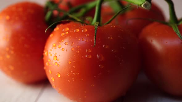 Red Tomatoes on White Wooden Background. The View From the Top. Washed Vegetables on a Branch with