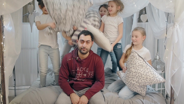 Five Children in the Fight Against a Young Father with Pillows