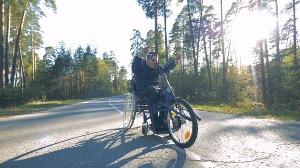 One Man Rides a Special Bicycle for Disabled People