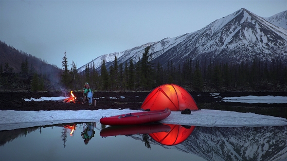 Woman Sitting and Drinking in a Camping in Mountains in the Evening