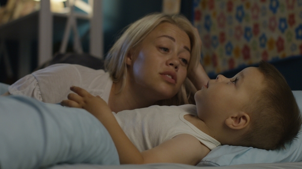 Woman Talking with Boy Before Falling Asleep