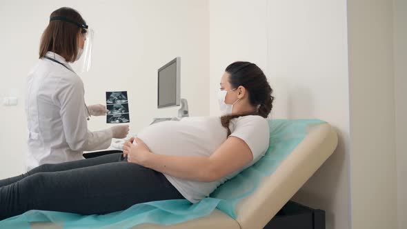 Gynecologist Showing Ultrasound Images for Pregnant Woman