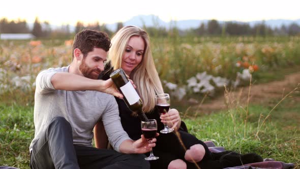 Couple having wine in pumpkin filed