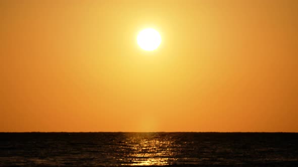 Dramatic Orange Sunrise Over the Beach. Red Sky, Yellow Sun and Amazing Sea. Summer Sunset Seascape