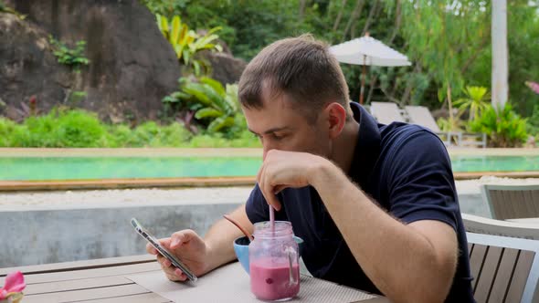 Modern Man Hipster Use Smartphone in Tropical Restaurant Trip to Bali or Phuket