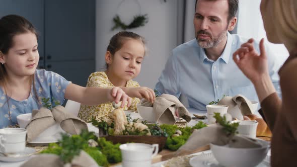 Caucasian family of five spending time over table on easter time. Shot with RED helium camera in 8K.