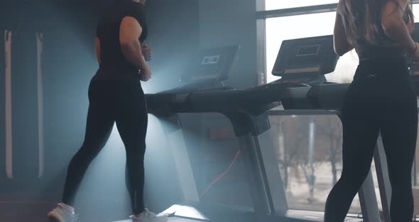 Woman and Man Running on Treadmill at the Gym