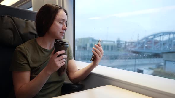 An Adult Woman Travels By Train and Communicates Via the Internet Via Video Link