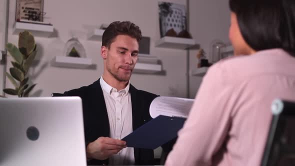 Man Interviewing Woman and Shaking Hands at Table During Meeting in Modern Office Spbi