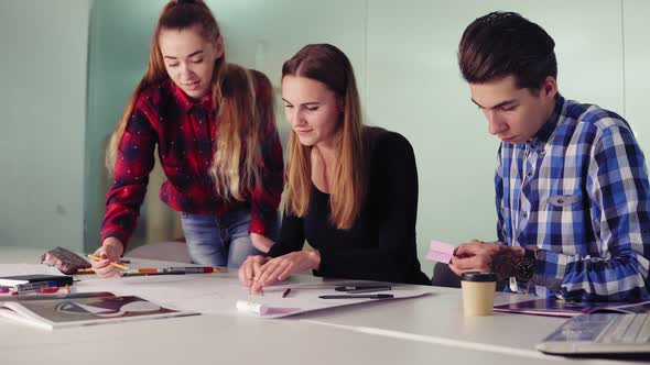 Group of Interior Designers Making Sketches and Drafts Painting with Pencils and Ruler