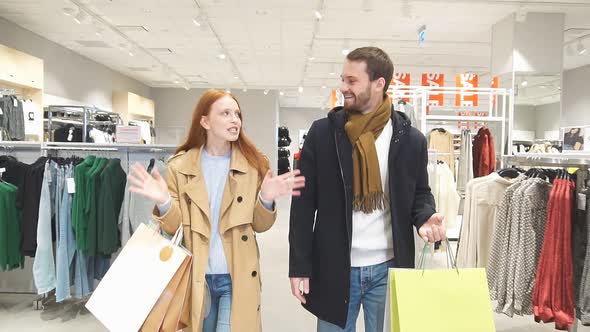 Happy Couple Coming Out of Clothing Store