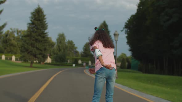 African Girl Learning To Ride Roller Skates in Park