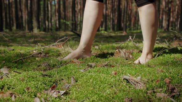 Woman Walking Barefoot on Soft Green Moss in the Forest in Sunny Day